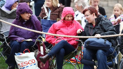 Spectators wait in the grounds of the Castle. AFP