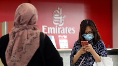A traveller wears a mask at the Dubai International Airport. The UAE now has 85 confirmed cases of the virus and the country is stepping up measures to protect residents.