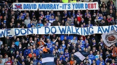 Rangers fans display banners during the a Scottish Premier League match at Ibrox Stadium, Glasgow. PA