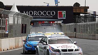 Andy Priaulx holds off Yvan Muller in Marrakech yesterday to take victory.