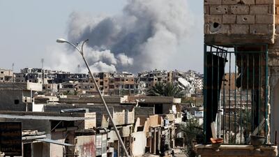 Smoke rises after a coalition air strike near a stadium in Raqqa where ISIL fighters were taking shelter on October 12, 2017. Local officials said on October 14 that a deal was reached for the militants to evacuate the Syrian city. Erik De Castro / Reuters