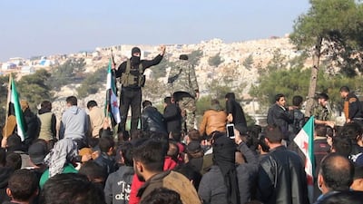 In this frame grab from video militants of the Al Qaida-linked Hayat Tahrir al-Sham try to disperse people who have gathered at the Bab al-Hawa border gate to protest the ongoing bombing campaign in Syria's rebel-controlled Idlib province by the government and its Russian ally. AP Photo