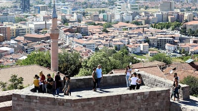 Tourists enjoy the view over the city as they visit Ankara Castle (Ankara Kalesi) in Ankara. AFP