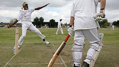 Ted Hayes, co-founder, player and coach of the Compton Cricket Club, bowls against the Simi Sluggers.