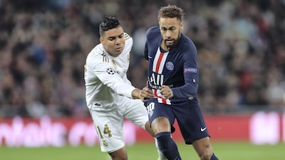 Neymar runs with the ball past Casemiro of Real Madrid during the Champions League group A match between Real Madrid and Paris Saint-Germain at Bernabeu. Getty