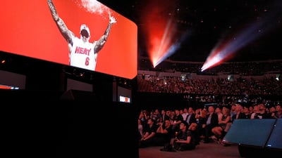 The audience watches Miami Heat star LeBron James in a game demonstration at the Sony news conference. David McNew / Reuters