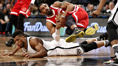 Memphis Grizzlies guard Mike Conley tumbles over Brooklyn Nets forward Thaddeus Young. Kathy Willens / AP Photo
