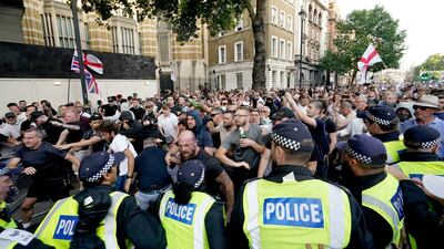 Police officers clash with protesters in Whitehall, London. AP