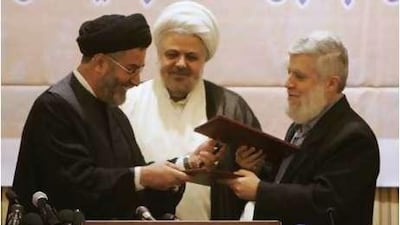 Shiite Ibrahim Amin al-Sayyed, (left), head of Hezbollah political bureau exchanges the "document of understanding" with Sunni Hassan al-Shahhal, a representative of some Salafist groups in Beirut today.