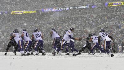 Minnesota quarterback Matt Cassel hands off to Adrian Peterson in the snow in Baltimore. Gail Burton / AP
