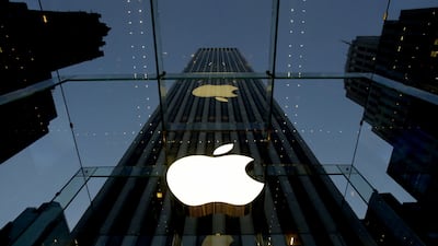 The Apple logo is illuminated in the entrance to the Fifth Avenue Apple store, in New York. Apple will replace AT&T in the Dow Jones industrial average after the close of trading on Wednesday, March 18, the manager of the index announced. AP Photo