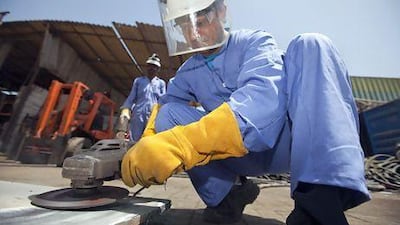 Arif Mirza learns the basic skills of a scrap yard worker in Dubai's Ras Al Khor industrial zone. Jaime Puebla / The National