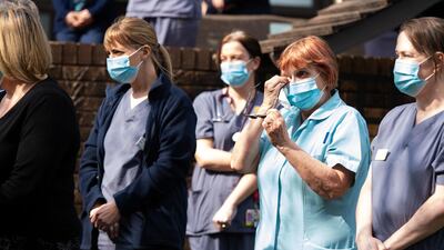 Staff of a Marie Curie hospice take part in a minutes silence in Penarth, Wales. Getty Images