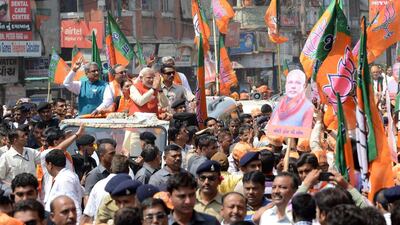 Gujarat state Chief Minister and BJP's prime ministerial candidate, Narendra Modi greets supporters during his roadshow in Vadodara, some 110 kms from Ahmedabad. Sam Panthaky / AFP Photo