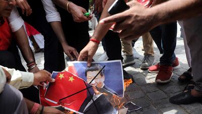 Right-wing Hindu activists angry at China for stopping Indian pilgrims from crossing the border burn posters portraying Chinese president Xi Jinping and the Chinese national flag during a protest in New Delhi on July 4, 2017. Rajat Gupta / EPA