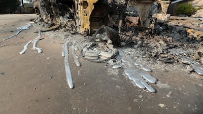 Molten aluminum has flowed from a car that burned in front of one of at least 20 homes destroyed in the Point Dume area of Malibu. AP Photo