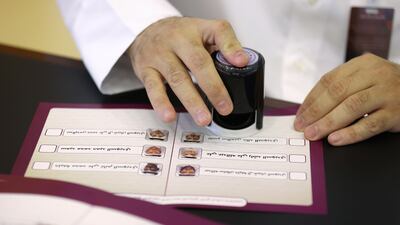 An official stamps a ballot paper. Reuters