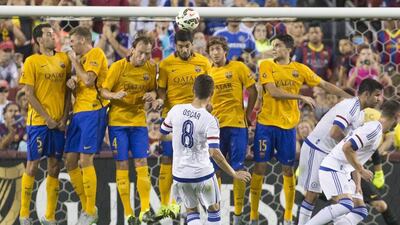 Chelsea's Oscar attempts a free kick over Barcelona's wall on Tuesday during their International Champions Cup pre-season match in the US. Michael Reynolds / EPA