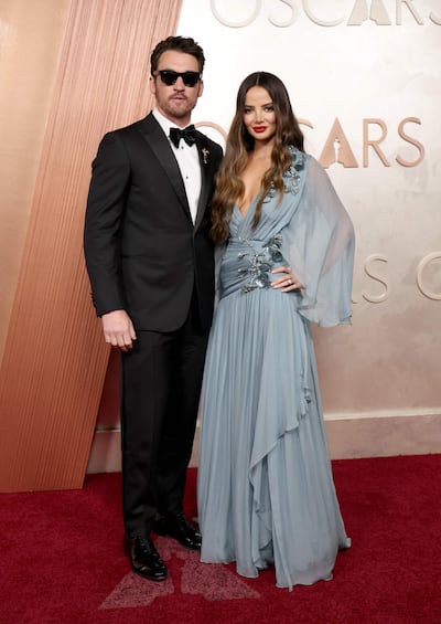 Keleigh Teller, in a Zuhair Murad dress, with her husband, actor Miles Teller. AFP