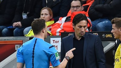 Referee Felix Zwayer, left, tells to Leverkusen's coach Roger Schmidt to leave the field during a German Bundesliga match between Bayer Leverkusen vs Borussia Dortmund on Sunday. Dortmund went on to win 1-0. Patrick Stollarz / AFP