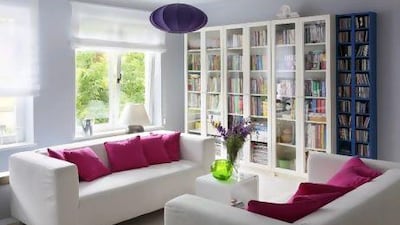 Hot pink is used sparingly in the main living area. This, along with the neutral grey walls and white sofas, and colourful accents such as the vivid green glass vase and purple ceiling lampshade, keep the bold, trendy colour from becoming overwhelming. Lukasz Zandecki / Gap Interiors