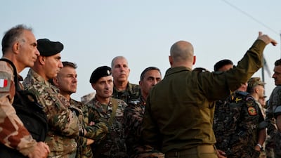 An Israeli commander addresses representatives of French and Indian forces at a site in the border town of Sderot, overlooking the devastated Gaza Strip. All photos: Reuters