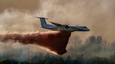 A fireguard aircraft drops retardant over a forest in Pouzols-Minervois in southwestern France after wildfires broke out in the region. AFP