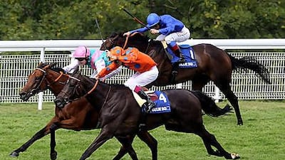 Tom Queally on board Midday, centre, wins from Stacelita, in the orange colours, ridden by Cristophe Soumillon, and the Frankie Dettori partnered Antara to win The Blue Square Nassau Stakes.