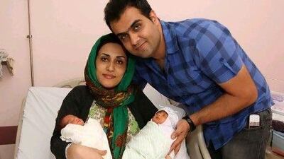 Fareed Al Din and Sheikha Al Mukhtari cradle two of their three daughters at Al Qassimi hospital. Their third baby is being kept in the neo-natal unit but her condition is stable.