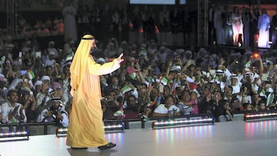 Sheikh Mohammed Bin Rashid waves to the crowd as he takes part in celebrations near Burj Khalifa marking the UAE national day and the victory for Dubai to host the 2020 Expo, in 2013. AFP