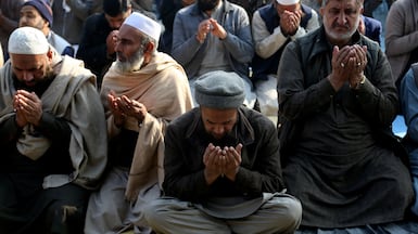 People gather for a congregational rain-seeking prayer at a park in Peshawar, Pakistan. EPA