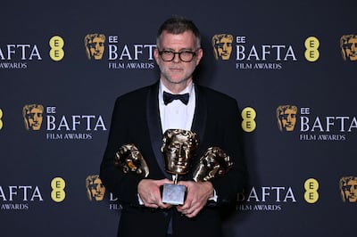 Paul Thomas Anderson with Bafta awards for One Battle After Another. AFP