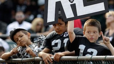 Young supporters of the Oakland Raiders show their affection for the late owner, Al Davis.