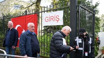 Turkish citizens living in Germany present identification before entering a polling station in Berlin. Reuters