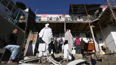 Afghan men gather at the site of a rocket attack at a residential house in Kabul, Afghanistan December 12, 2020. EPA