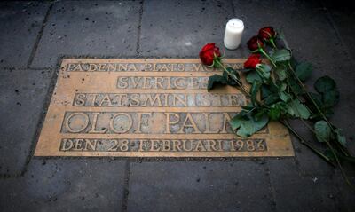 Roses are laid on a plaque marking the location where Swedish Prime Minister Olof Palme was shot and killed 25 years ago. Reuters