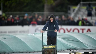 A groundsman at work in the rain as Ireland prepare to play their first ever cricket Test against Pakistan on Friday. Charles McQuillan / Getty Images
