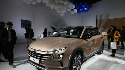 Visitors look at a Hyundai Nexo, a hydrogen fuel-cell powered vehicle. Jung Yeon-Je / AFP