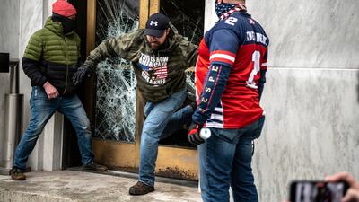 Far-right protesters break the door of the Capitol building during a protest against restrictions to prevent the spread of coronavirus in Salem, Oregon, US. Reuters
