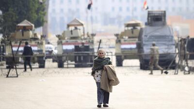 A woman crosses Tahrir Square’s entrance, which is blocked by armoured vehicles and barbed wire, on the fourth anniversary of the 2011 uprising that toppled autocrat Hosni Mubarak in Cairo, January 25, 2015. Mohamed Abd El Ghany / Reuters