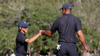 Charlie Woods with his father, Tiger. Reuters