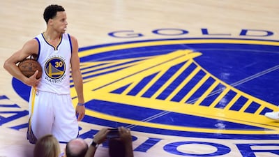 Stephen Curry of the Golden State Warriors holds on to the ball as the clock winds down in Game 5 of the 2015 NBA Finals against the Cleveland Cavaliers on June 14, 2015 at the Oracle Arena in Oakland, California. The Warriors defeated the Cavaliers 104-91 to lead the best of seven series 3-2. AFP PHOTO / FREDERIC J. BROWN