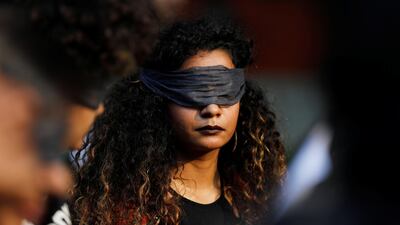 A protestor wearing a blindfold takes part in a demonstration in solidarity with rape victims and to oppose violence against women in India. REUTERS