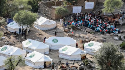 Earthquake-affected people receive relief aid distributed by the Aga Khan Development Network (AKDN) in the Dewa Gul Valley of Sawkay district in Kunar province. AFP