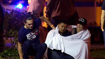 People comfort each other after the shooting. AP Photo