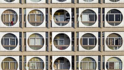 The Obeid Al Mazroui building (spellings vary) on Electra Street is a spectacle of modernist architecture. The circular design frames tenants' windows and prevents direct sunlight beating down onto them. It has been dubbed the Connect Four building by some long-time residents in reference to the game. Hussain AlMoosawi / The National