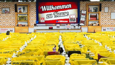 Early arrivals uncover their sofa to watch a 2014 World Cup match at a public viewing event at Berlin's Alte Forsterei stadium. home to Union Berlin, of the German second division, who have turned their stadium into a giant 'World Cup living room'. Thomas Peter / Reuters