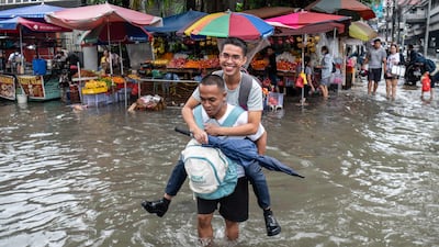 Continuous rain caused by the southwest monsoon that is being intensified by Typhoon Dolphin caused flooding in Manila and elsewhere. AFP