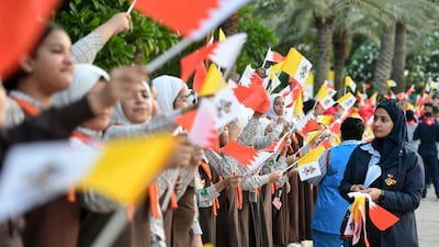 Schoolchildren prepare to welcome the Pope on the grounds of Sakhir Palace. Khushnum Bhandari / The National
