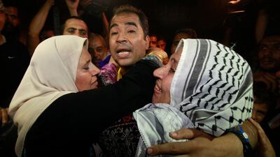 A freed Palestinian prisoner is hugged by his mother upon his arrival near Erez Crossing, between Israel and northern Gaza Strip. REUTERS / Mohammed Salem